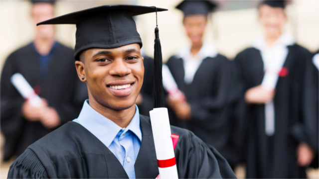 Student in graduation cap and gown, holding a diploma