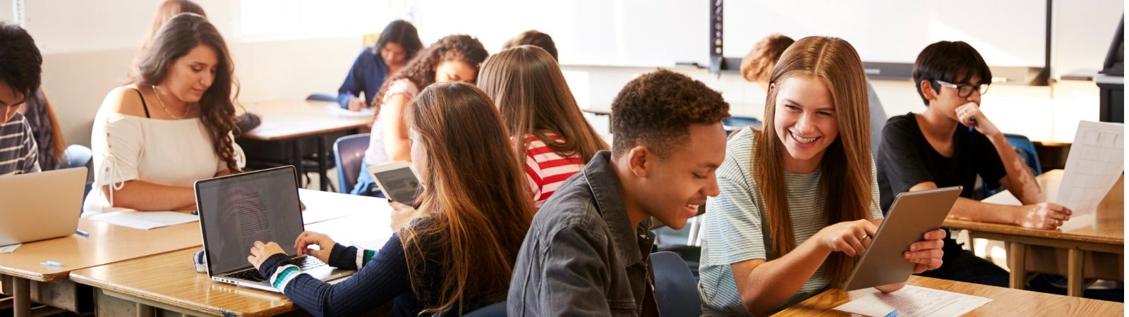 High school age students sitting in a classroom.